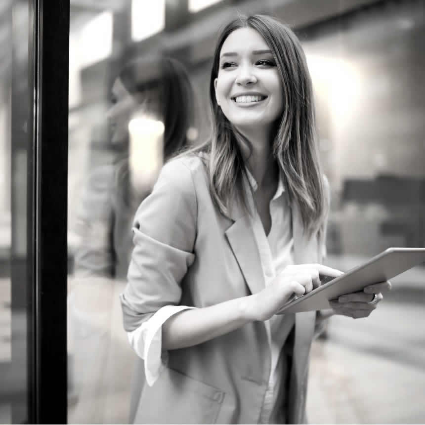 Urban happy business woman using tablet for learning and development purposes Urban happy business woman using tablet for learning and development purposes